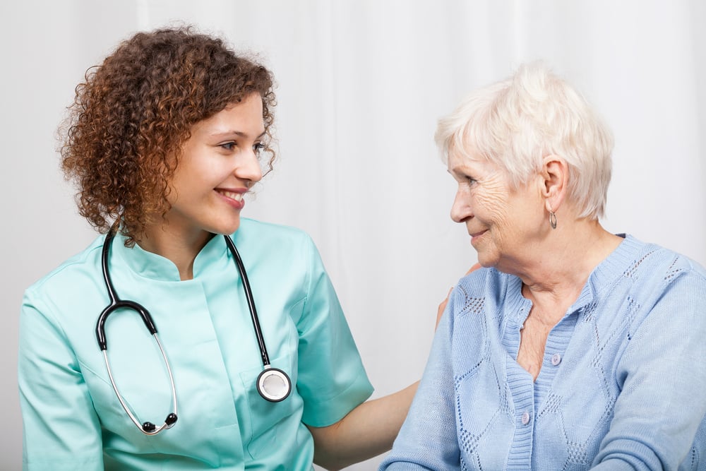 Smiling nurse and happy elderly lady, horizontal